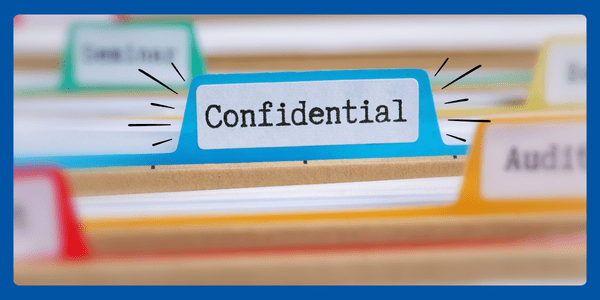 File folders with one labelled as 'Confidential.'