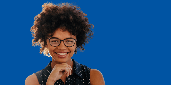 Woman wearing glasses smiling.